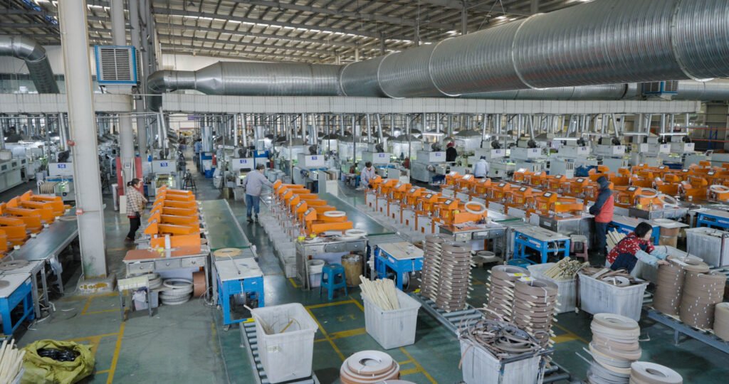 Technician operating edge banding extrusion machine in factory